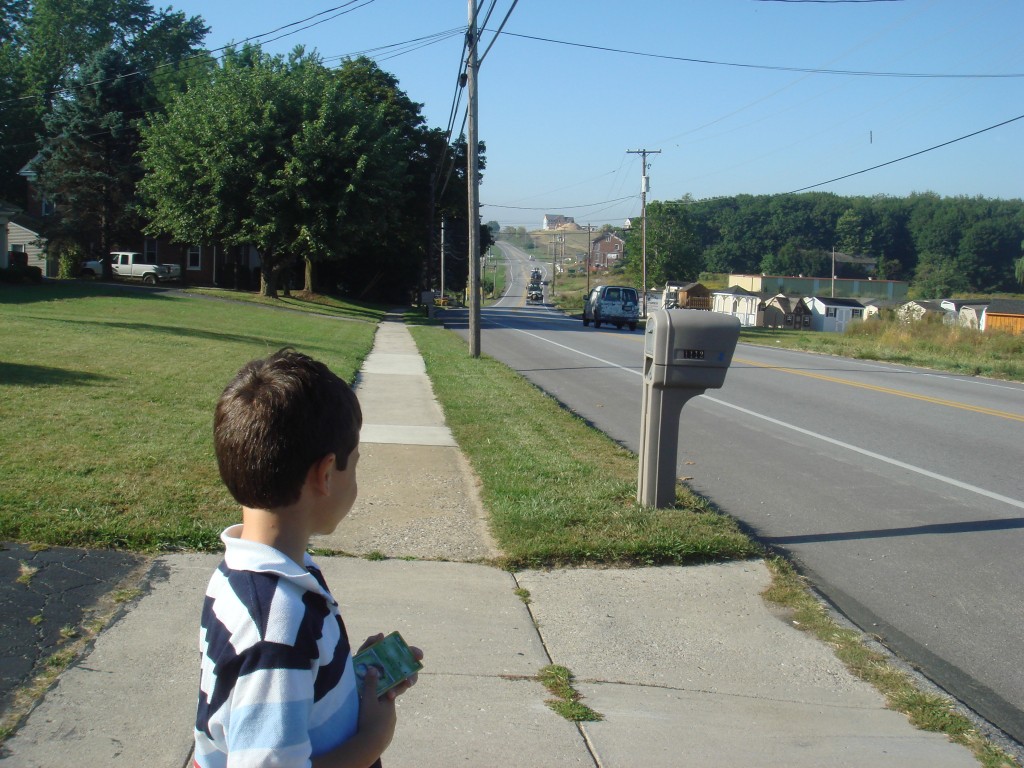 child next to country road