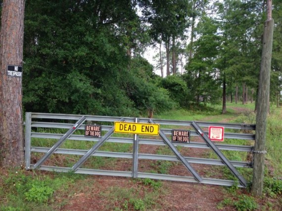 property gate with warning signs