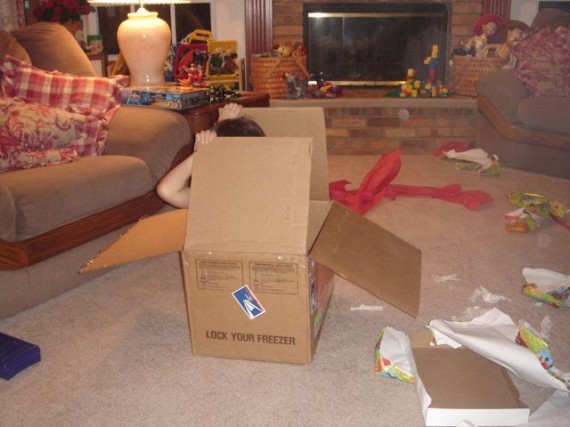 Child playing with box instead of toy inside