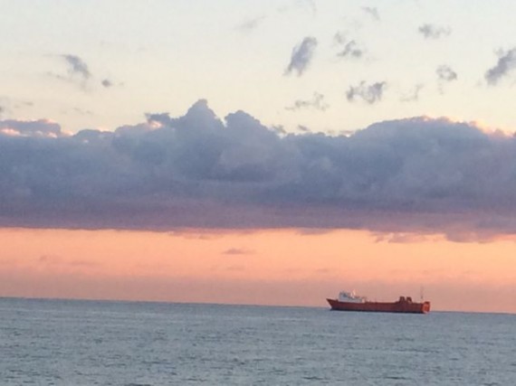 Freight ship off Palm Beach, Florida coast at sunrise