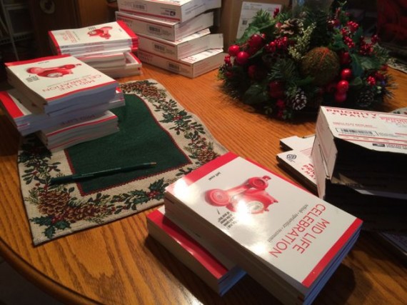 Piles of Mid Life Celebration books on dinner table