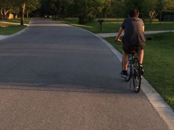 youth riding bike in central Florida neighborhood