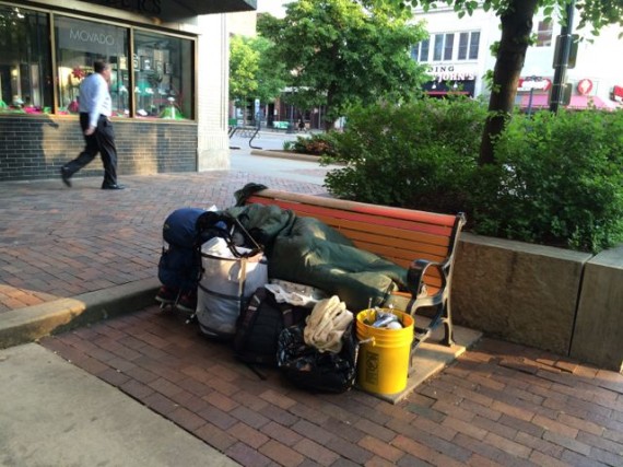 Homeless Iowa City person sleeping on city bench