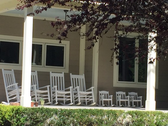 Adult and child rocking chairs on front porch