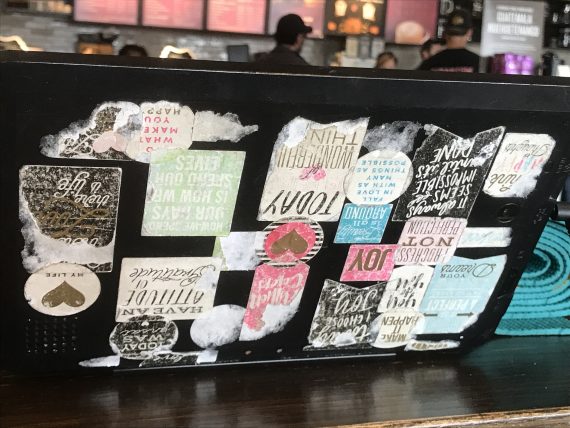Laptop covered in stickers at Starbucks