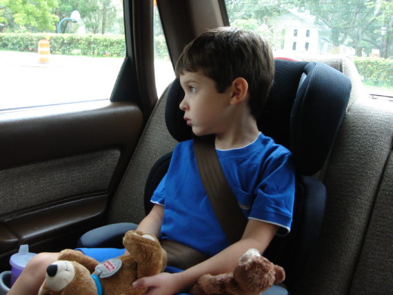 contemplative child in car seat