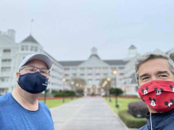 Two men wearing facemasks at Disney’s yacht club resort