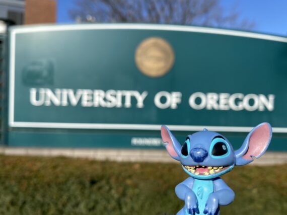 Stitch toy in front of University of Oregon sign