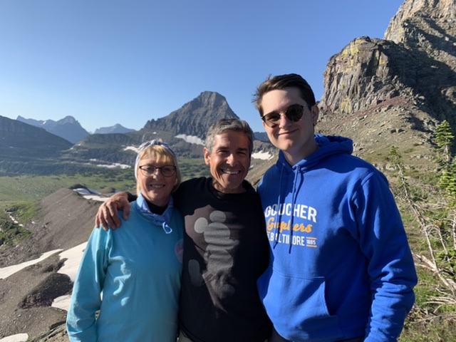 family posing in the mountains
