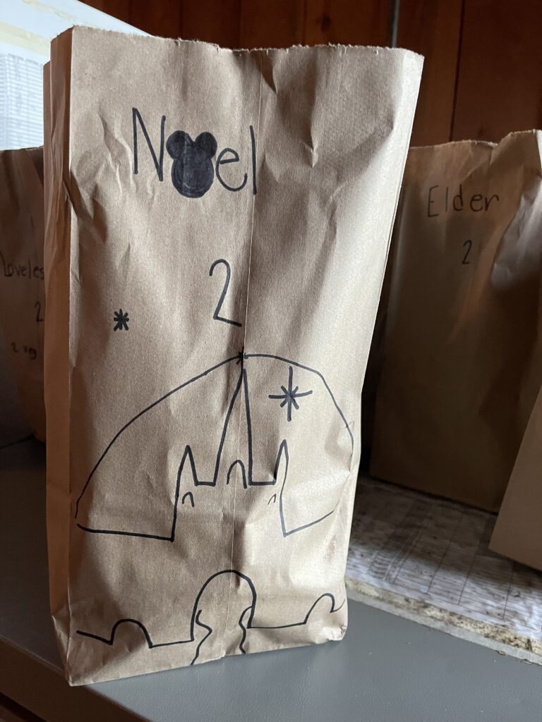 Brown lunch bag with handwritten castle art