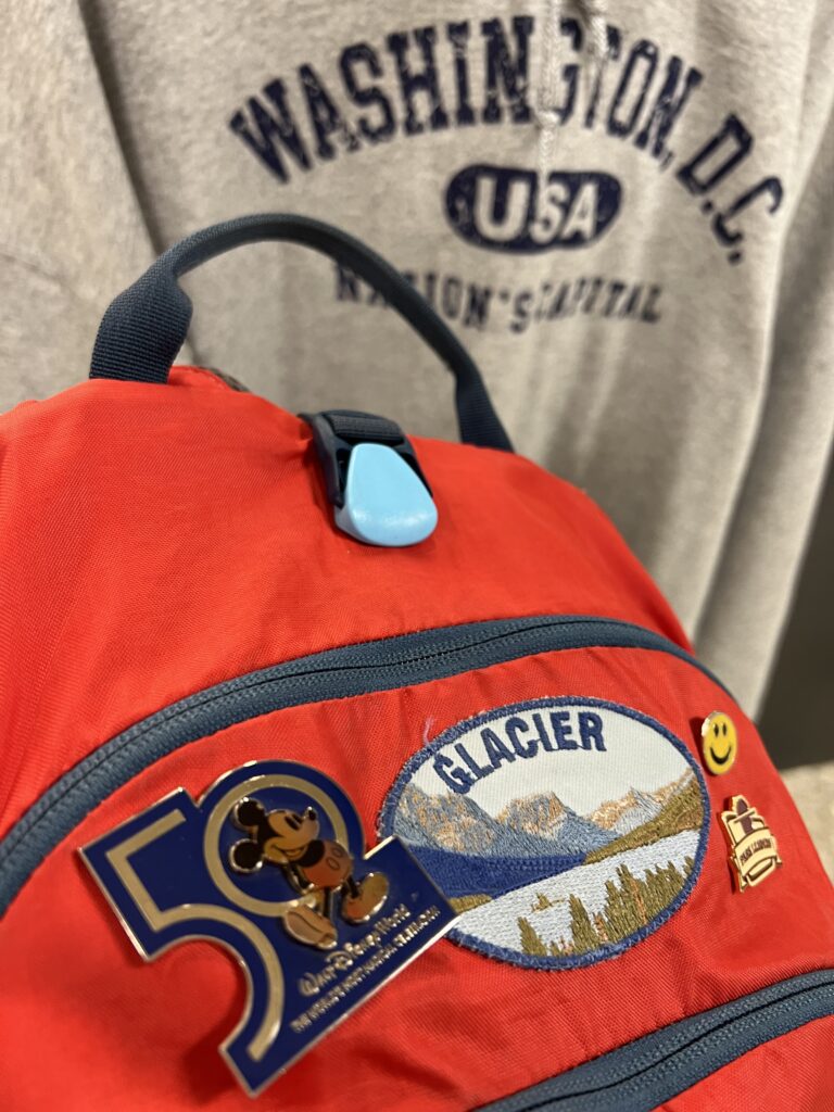 red backpack with buttons and patch
