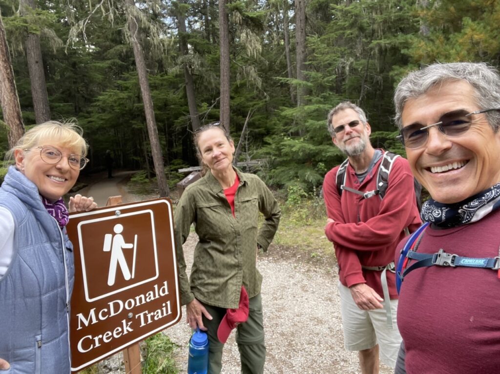 Two couples at hiking trailhead 