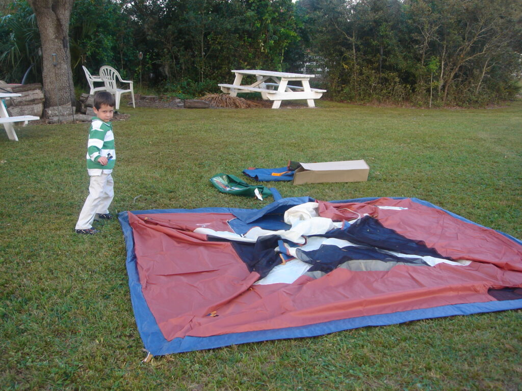 boy helping to set up tent