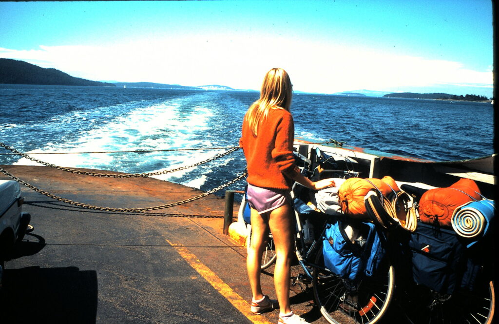 woman on ferry boat by two touring bicycles
