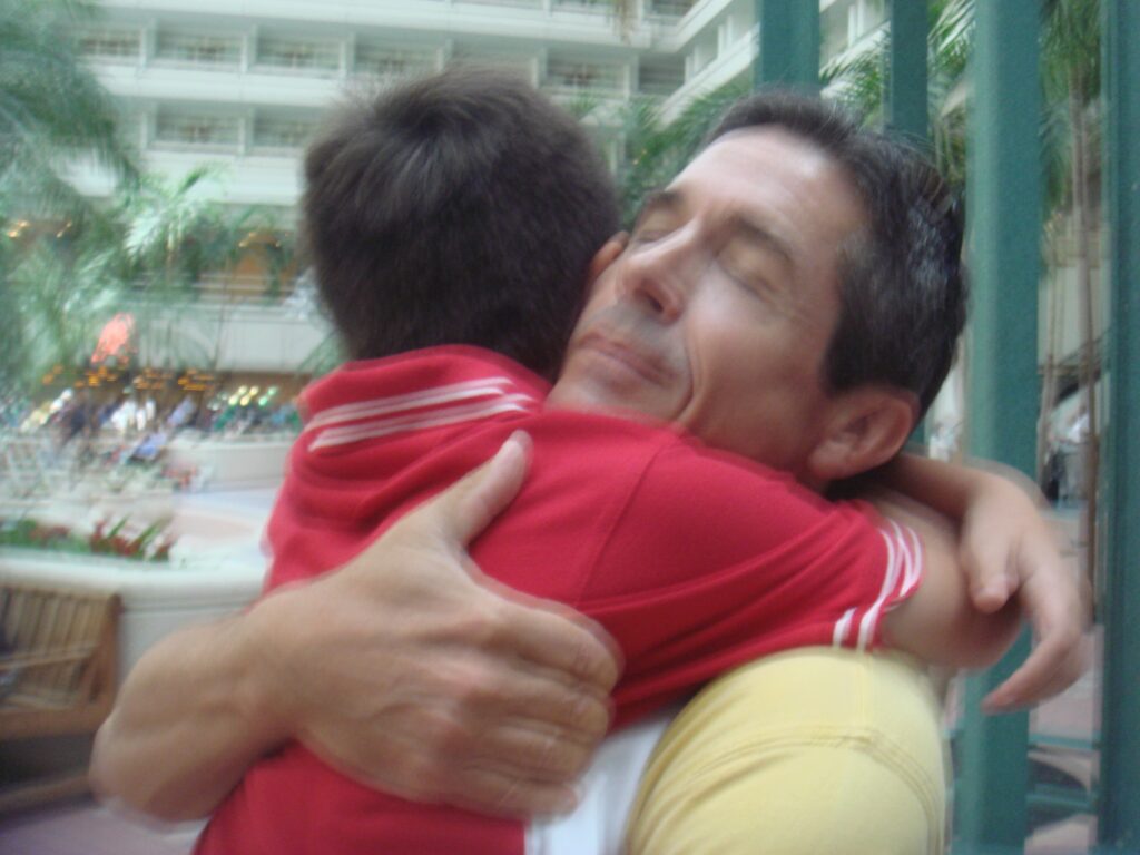 father hugging young son