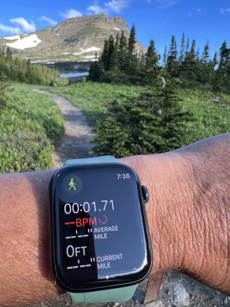 Apple Watch on someone’s wrist in the mountains