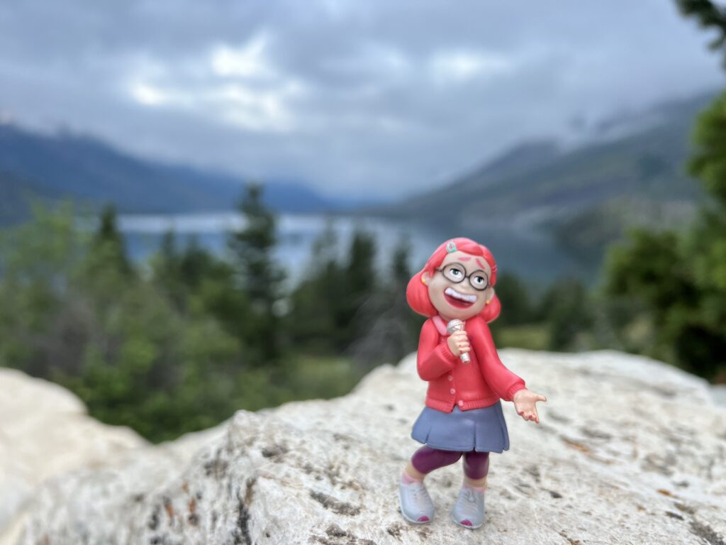 Small Disney figurine in the mountains