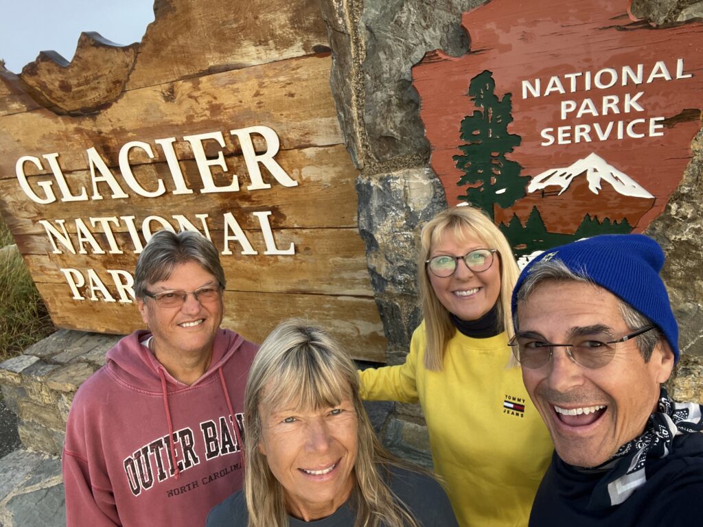 Four people at national park sign