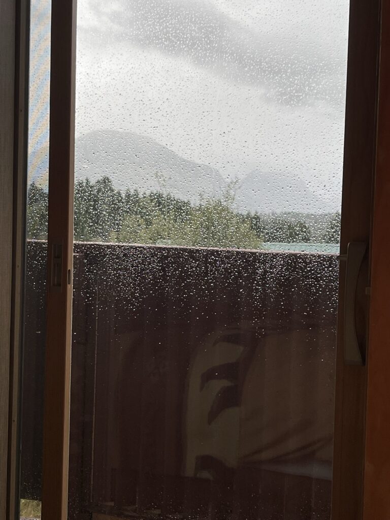 Large window covered in raindrops