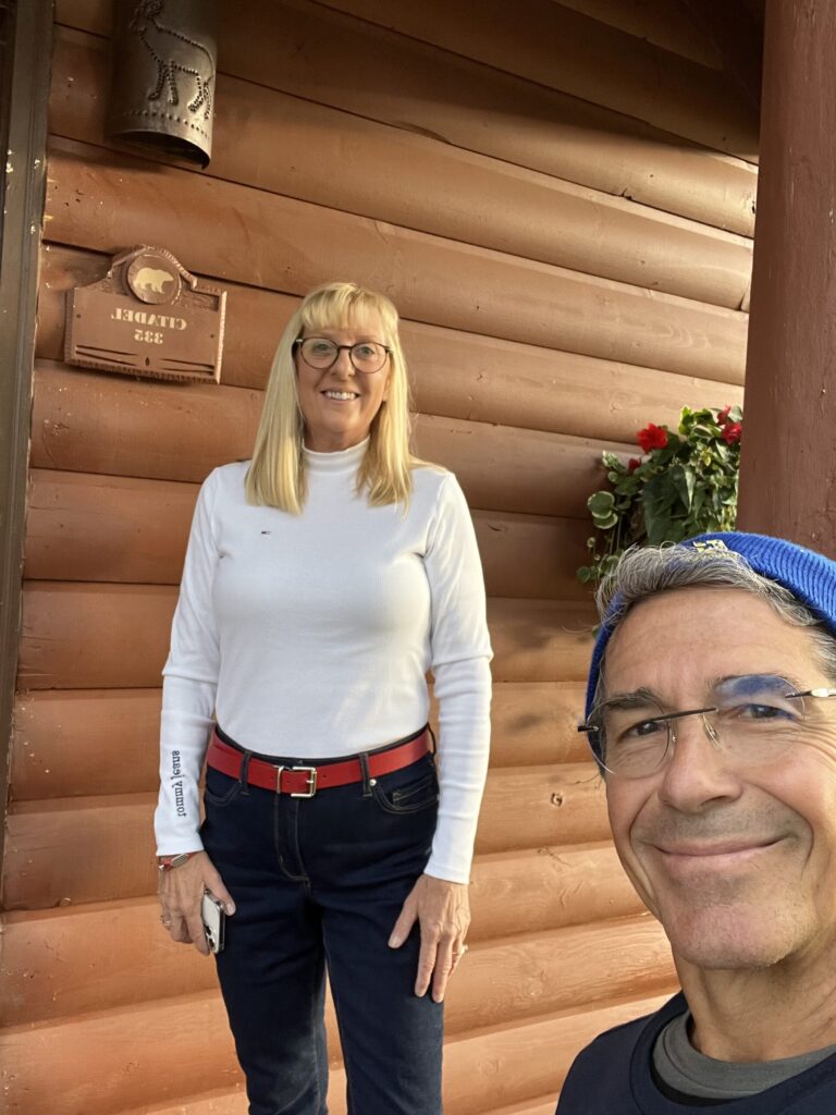 Couple posing by cabin door