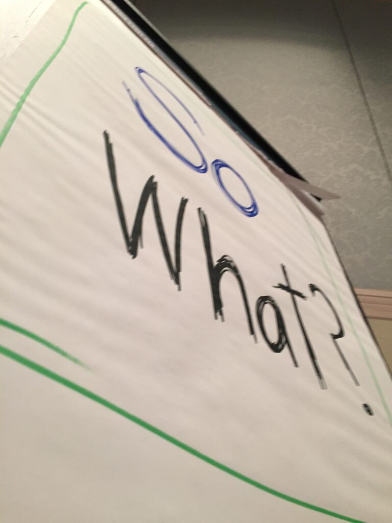 flip chart with 'so what' written on it