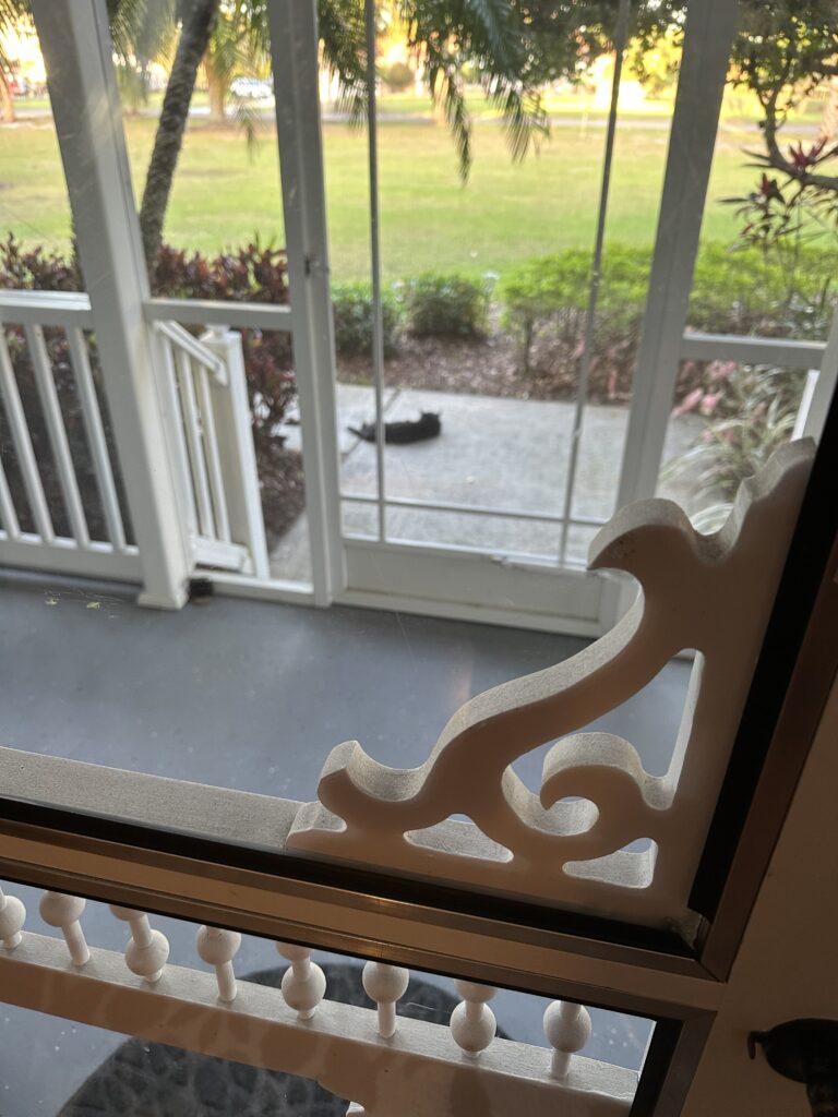 Black cat on a home sidewalk doorstep