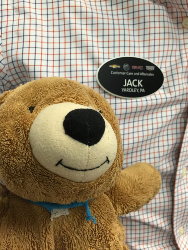 teddy bear next to a Jack name tag 