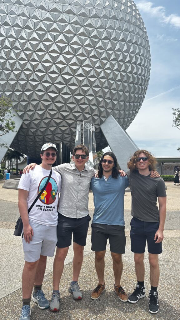 Four college seniors in front of spaceship Earth at Epcot