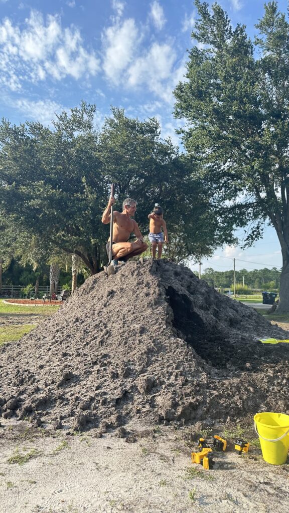 Two people on a dirt pile