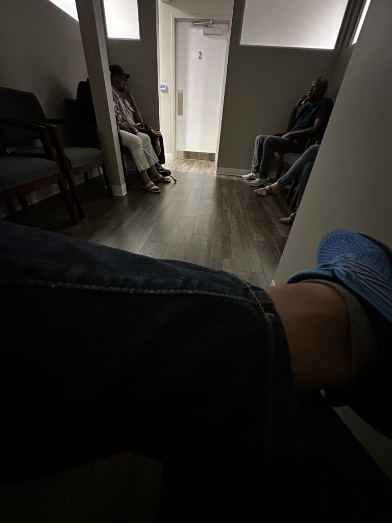 Persons lap in a dark waiting room
