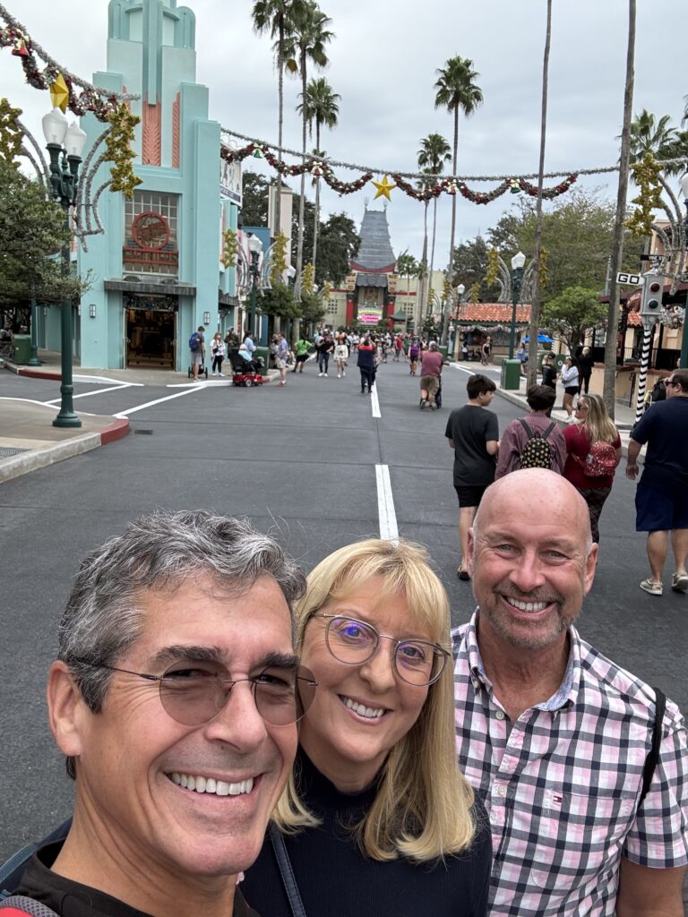 Three adults in a Disney theme park