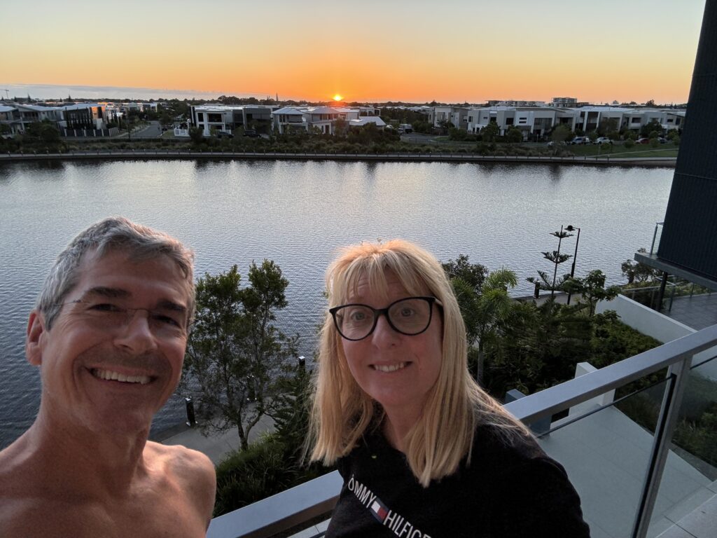 two people on balcony at sunrise