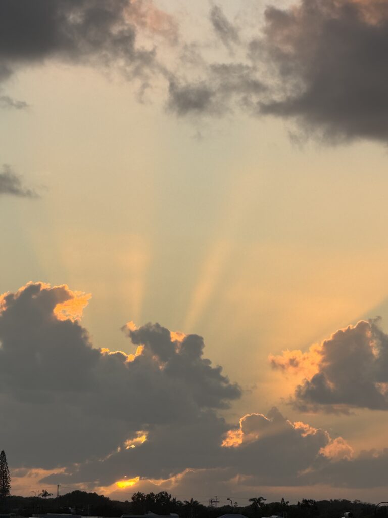 Sunrise shining light beams through the clouds