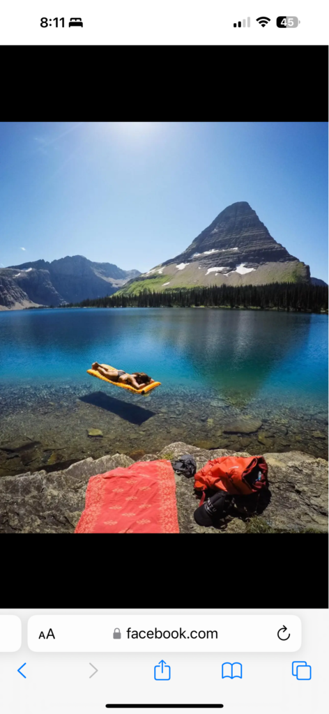 Mountain lake and person on raft