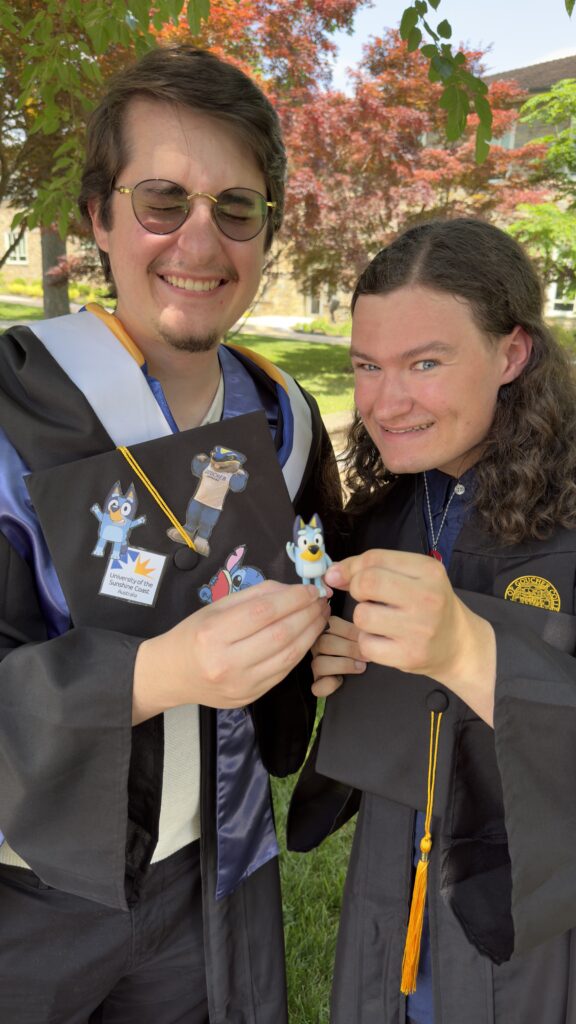 Two college graduates posing for a picture