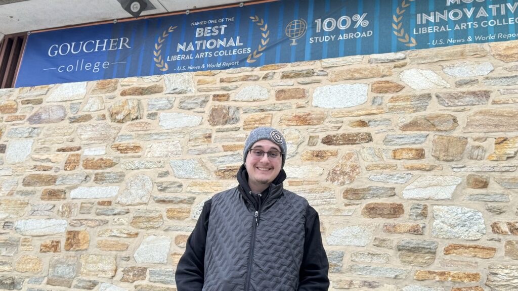 Person standing in front of a stonewall