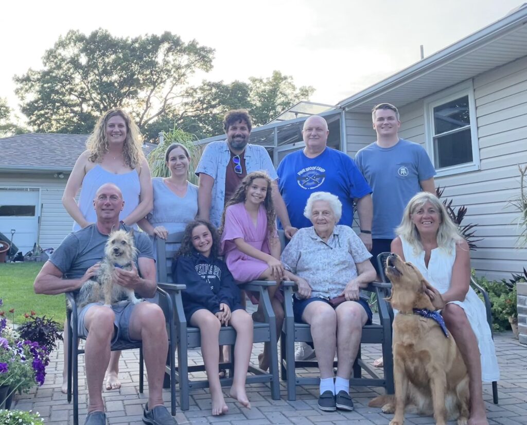 10 people posing for family photo outside