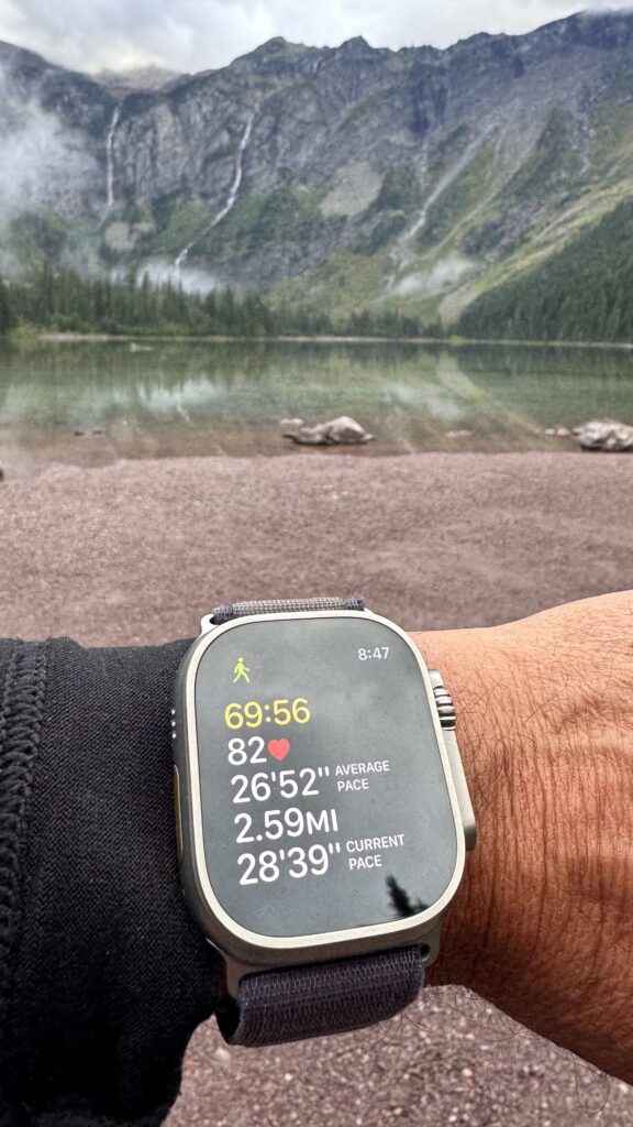 apple watch fitness screen next to mountain lake