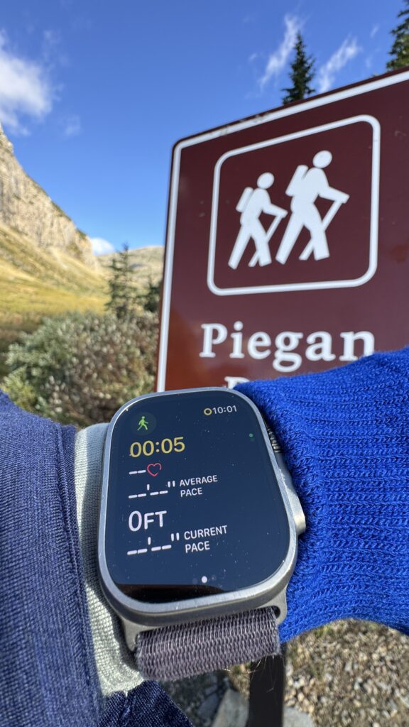 Apple Watch fitness app at trailhead sign