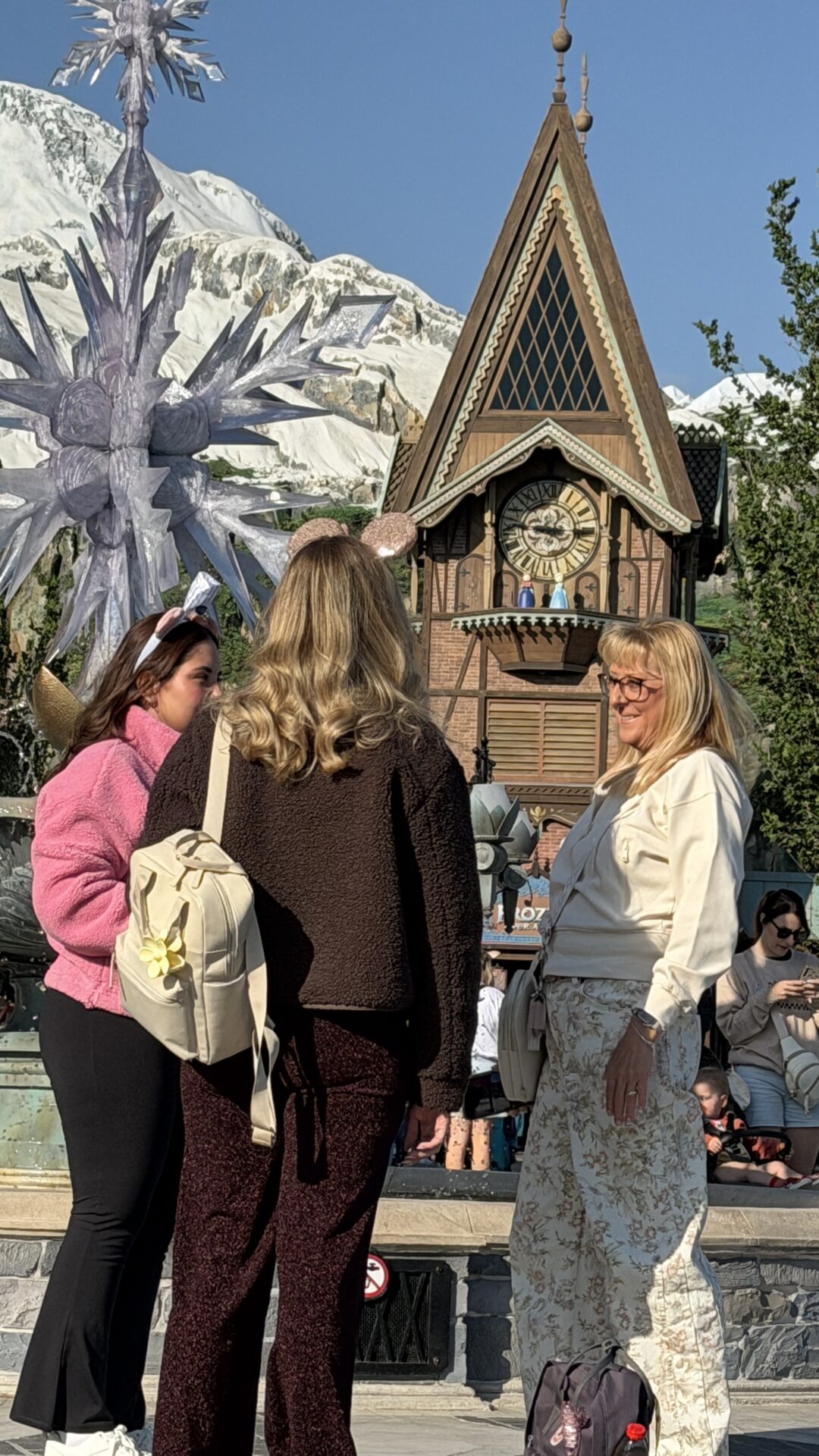 Three women talking in a Disney theme park