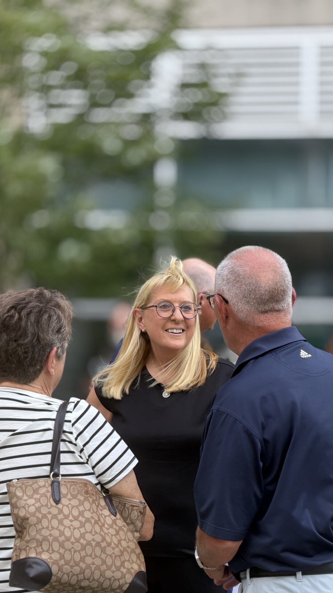 Blond woman in a small crowd