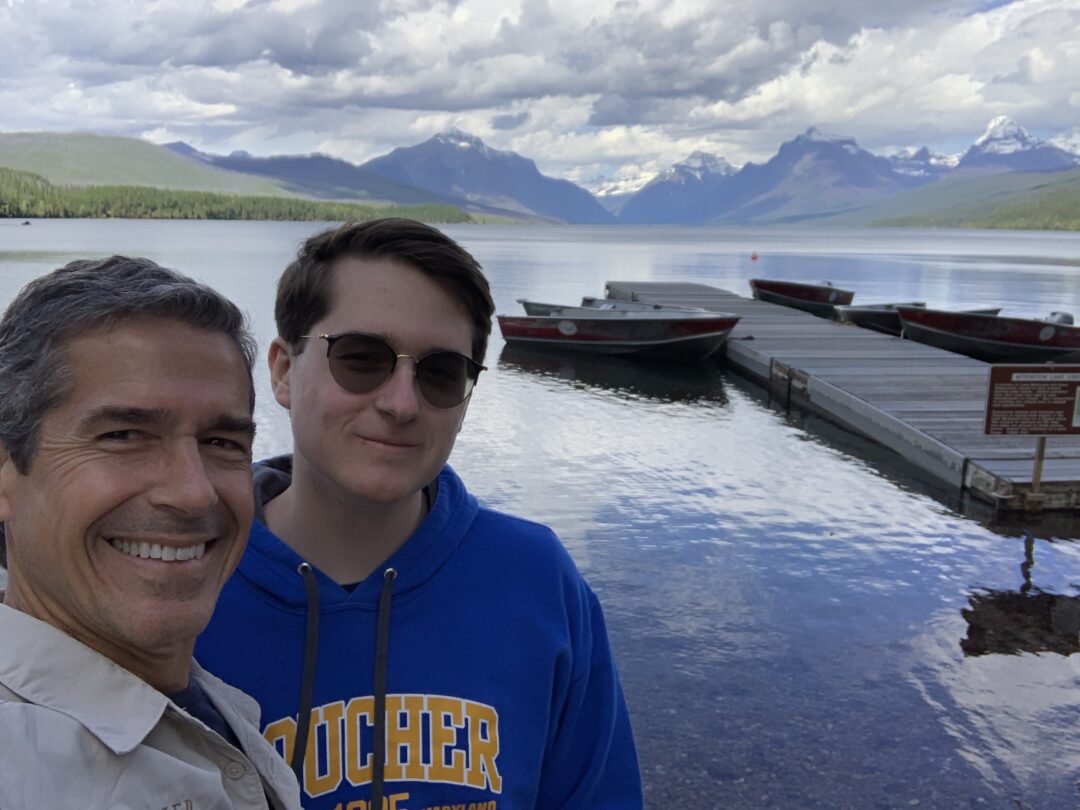 father and son at mountain lake in Glacier National Park