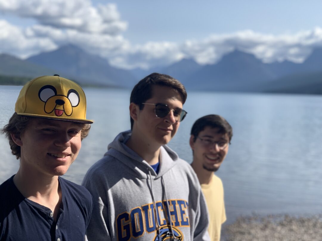 three college freshmen by mountain lake in Glacier National Park